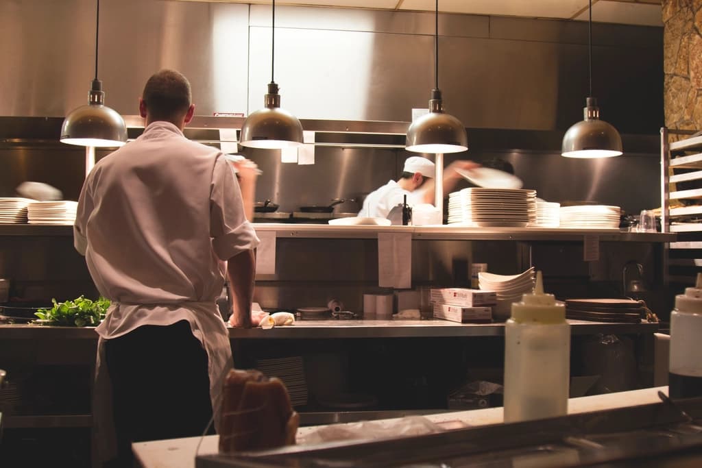 Chefs working along a busy restaurant kitchen line
